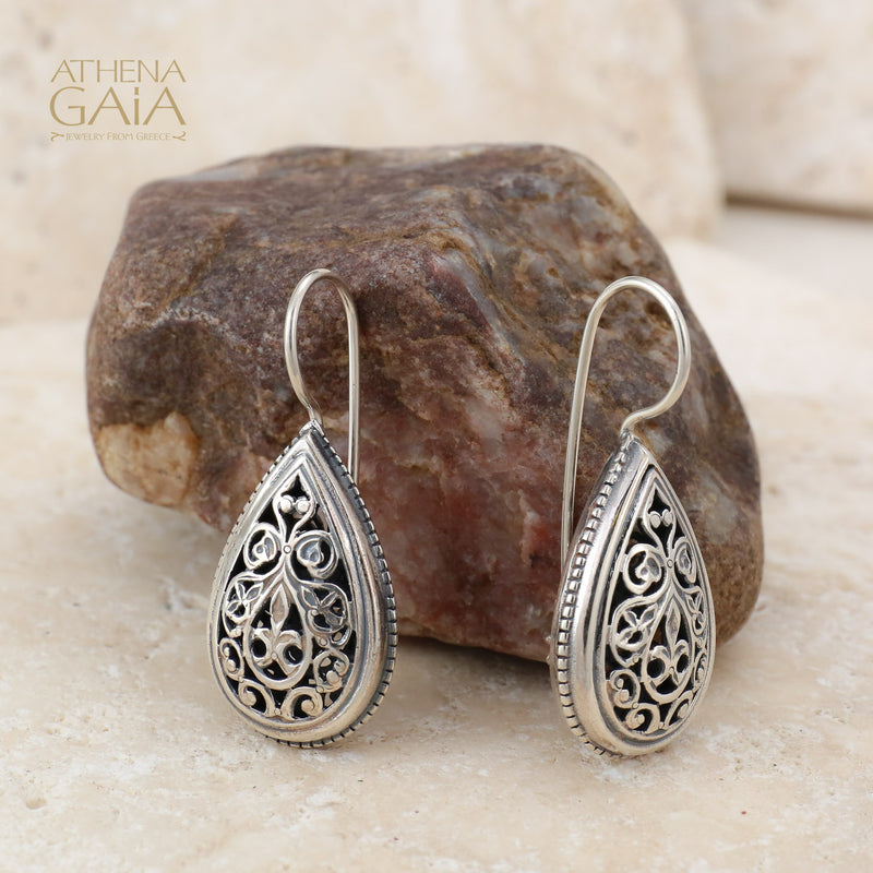 Teardrop-shaped silver earrings with intricate filigree detailing, blending elegance and handcrafted artistry