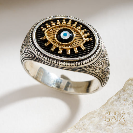 Sterling Silver and 18k Gold ring with an evil eye design on a light background