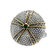 A large sea urchin-shaped ring with a central stone, featuring silver and gold detailing.