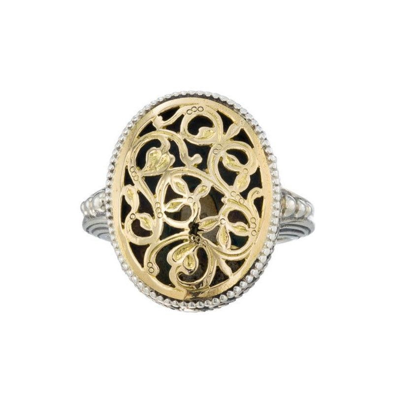 A medium sized oval filigree ring with floral patterns on the face.