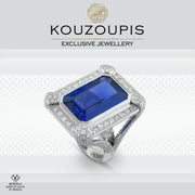 Silver ring with a blue gemstone and diamond accents on a white background, featuring the Kouzoupis brand.