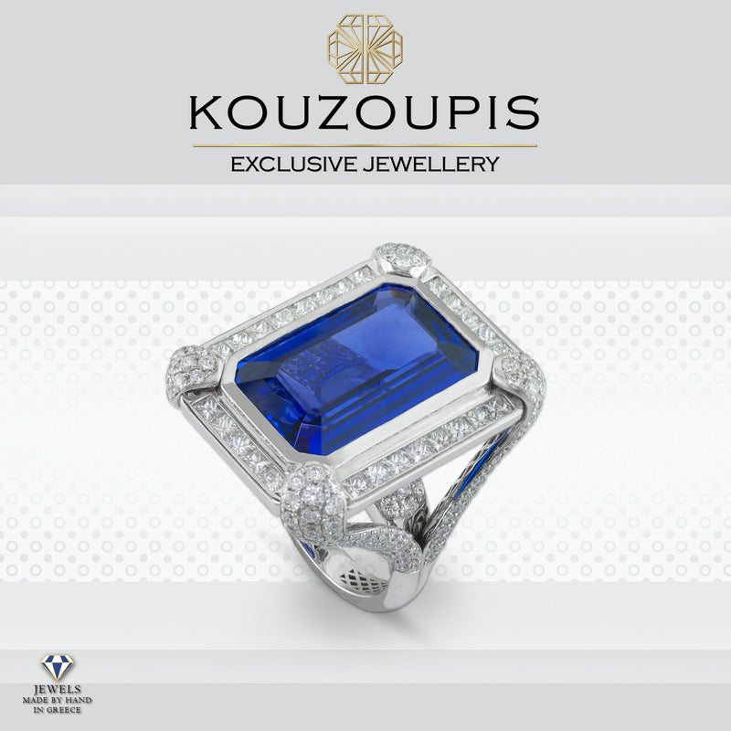 Silver ring with a blue gemstone and diamond accents on a white background, featuring the Kouzoupis brand.