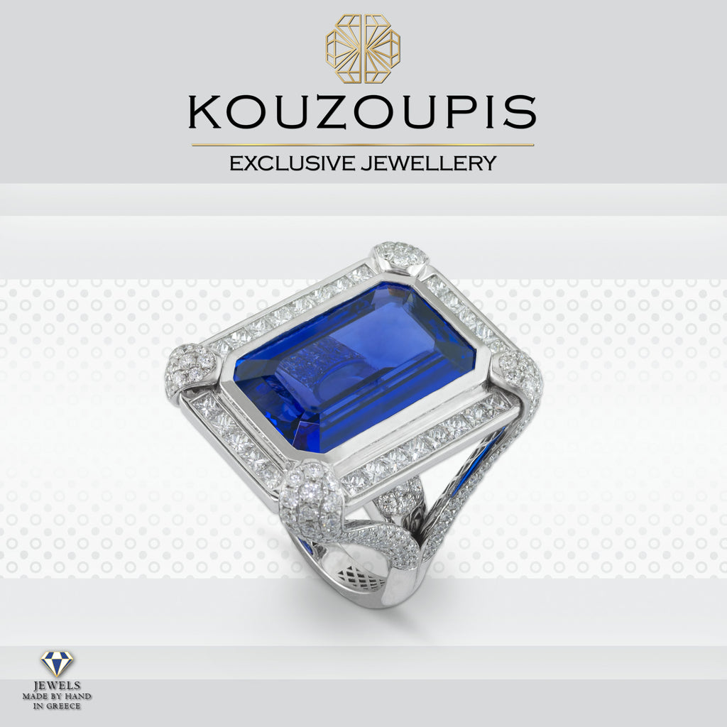 Silver ring with a blue gemstone and diamond accents on a white background, featuring the Kouzoupis brand.