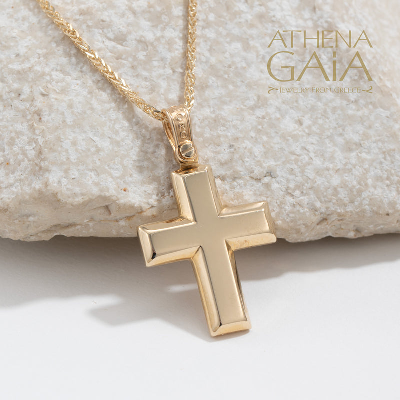 beveled yellow gold Baptism cross necklace on a white rock background