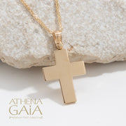 back view of a yellow gold Baptism cross on a white background