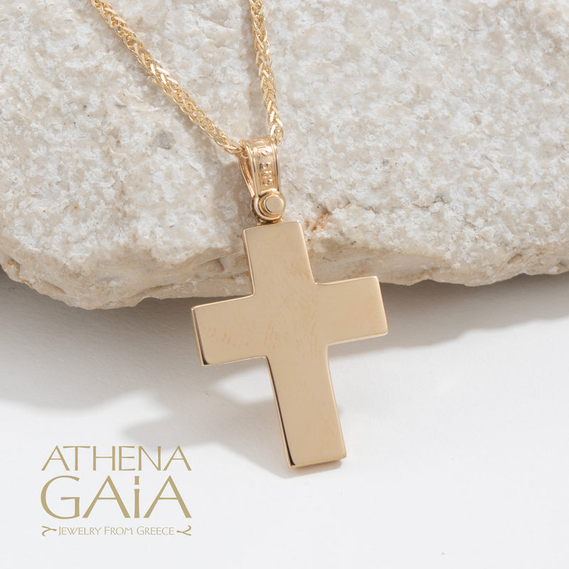 back view of a yellow gold Baptism cross on a white background