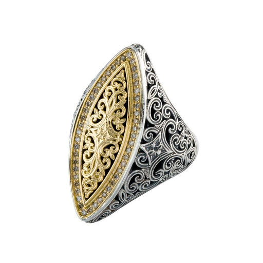 Decorative ring with gold and silver filigree design on a white background