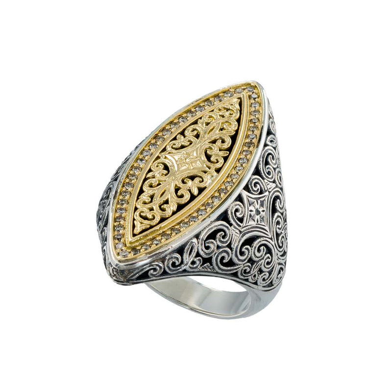 Decorative ring with gold and silver filigree design on a white background