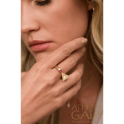 A model wearing an open ring with two faces