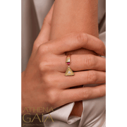 A model wearing an open ring with two faces