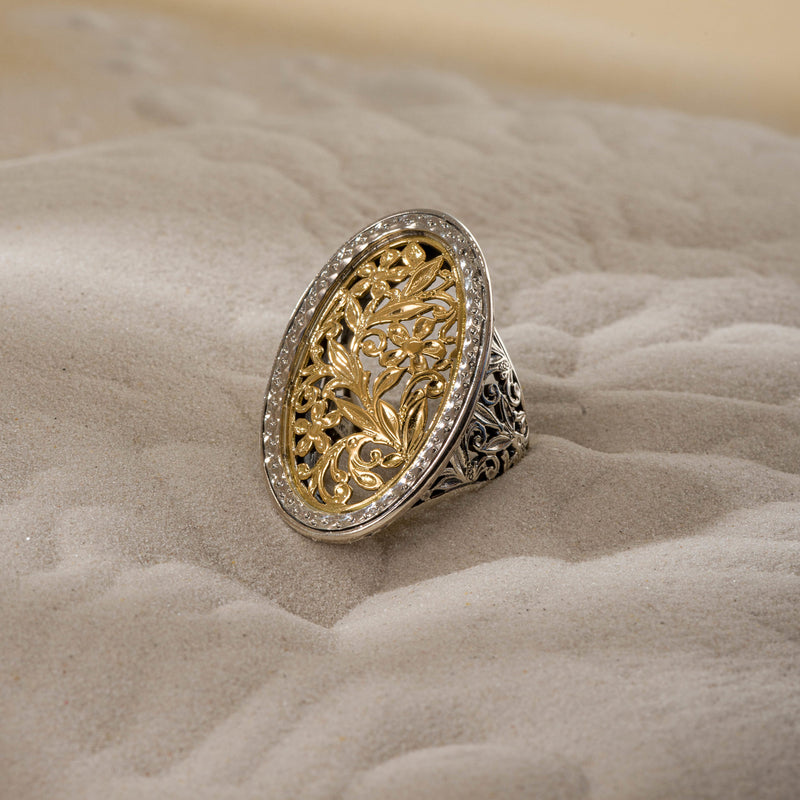 A large oval filigree ring with floral patterns on the face and shank