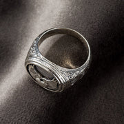 Silver ring with intricate winged heart design