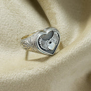 Silver ring with heart and wings design