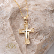 14k gold Orthodox Baptism cross necklace shown on a beige rock