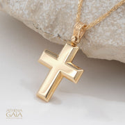 beveled yellow gold Baptism cross on a white background