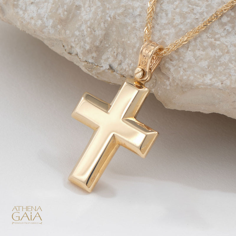 beveled yellow gold Baptism cross on a white background