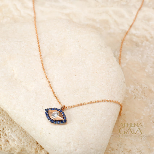 A symbol of protection and divine watchfulness, adorned in deep blue sapphires