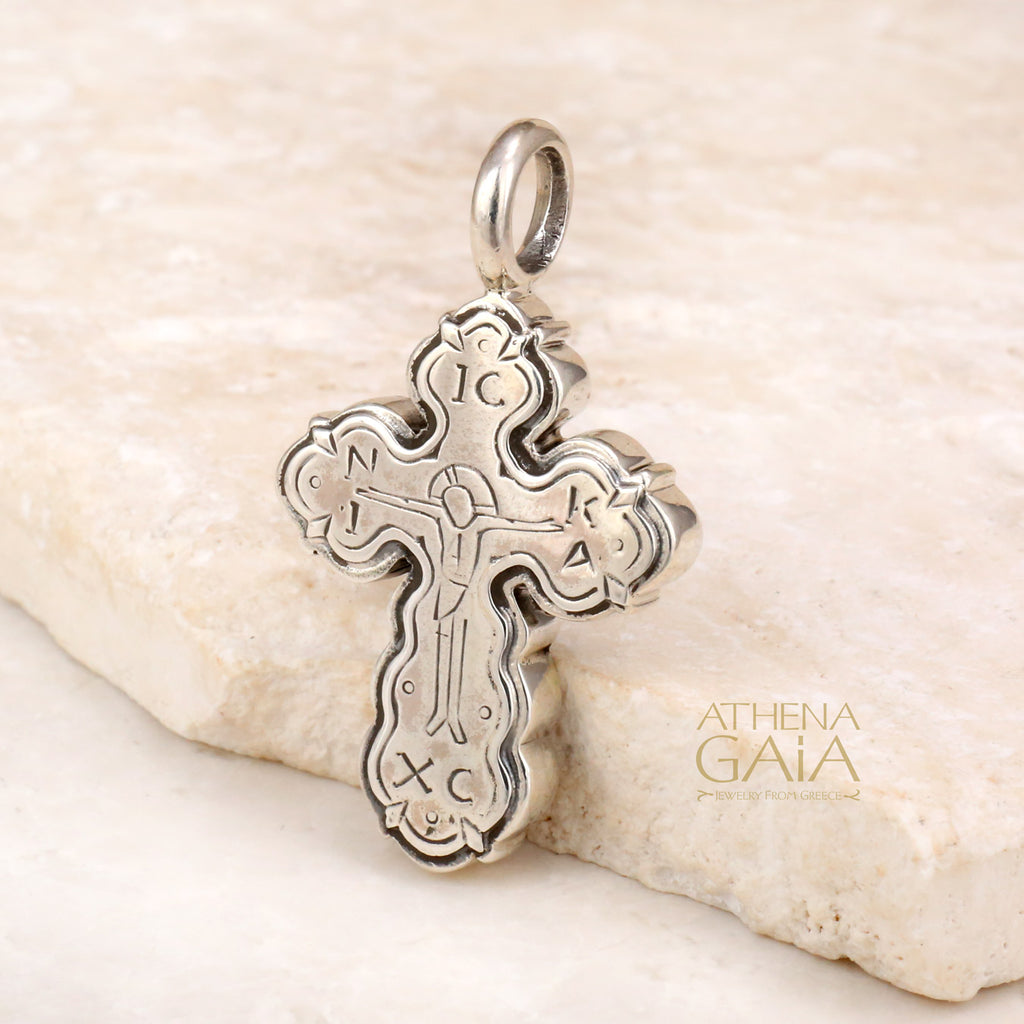 Handcrafted silver cross pendant with engraved Byzantine details, radiating faith and tradition
