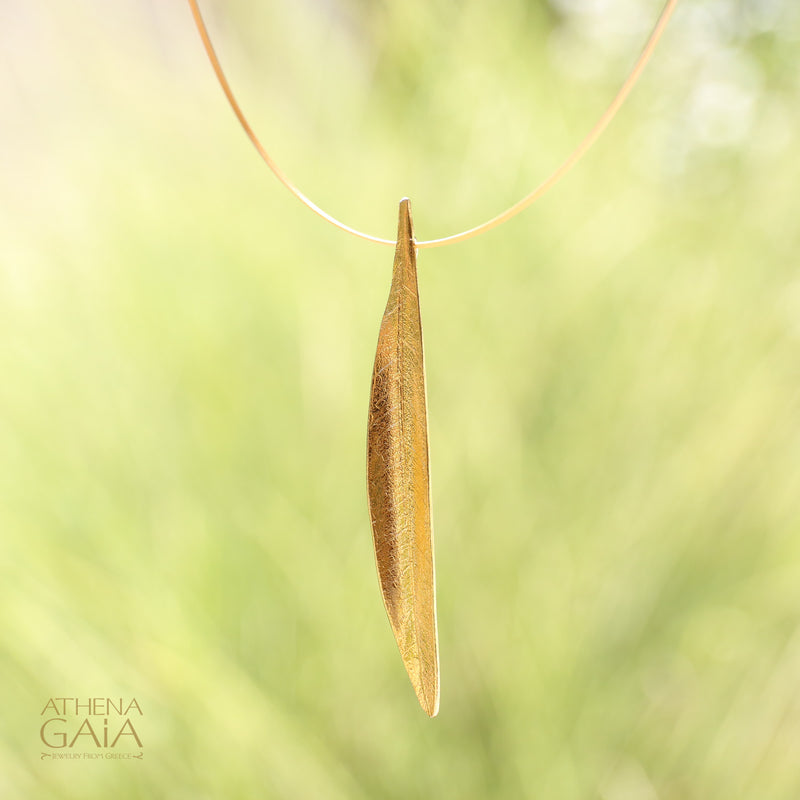 Gracefully shaped and gold-plated, this pendant captures the essence of an olive leaf — a timeless Greek symbol of peace and prosperity.