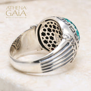 A silver ring with a blue stone featuring Ionic column designs and a Meander Greek key pattern.