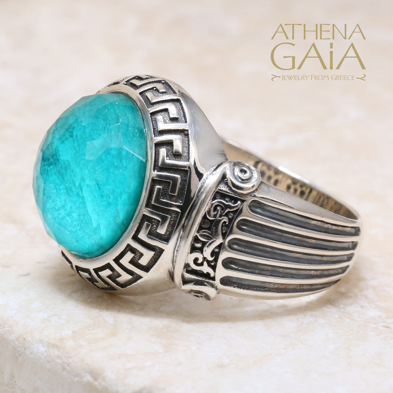 A silver ring with a blue stone featuring Ionic column designs and a Meander Greek key pattern.