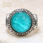 A silver ring with a blue stone featuring Ionic column designs and a Meander Greek key pattern.