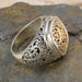 Men’s silver ring with ornate filigree sides and gold scrollwork face, handcrafted Greek design.