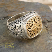 Men’s silver ring with ornate filigree sides and gold scrollwork face, handcrafted Greek design.