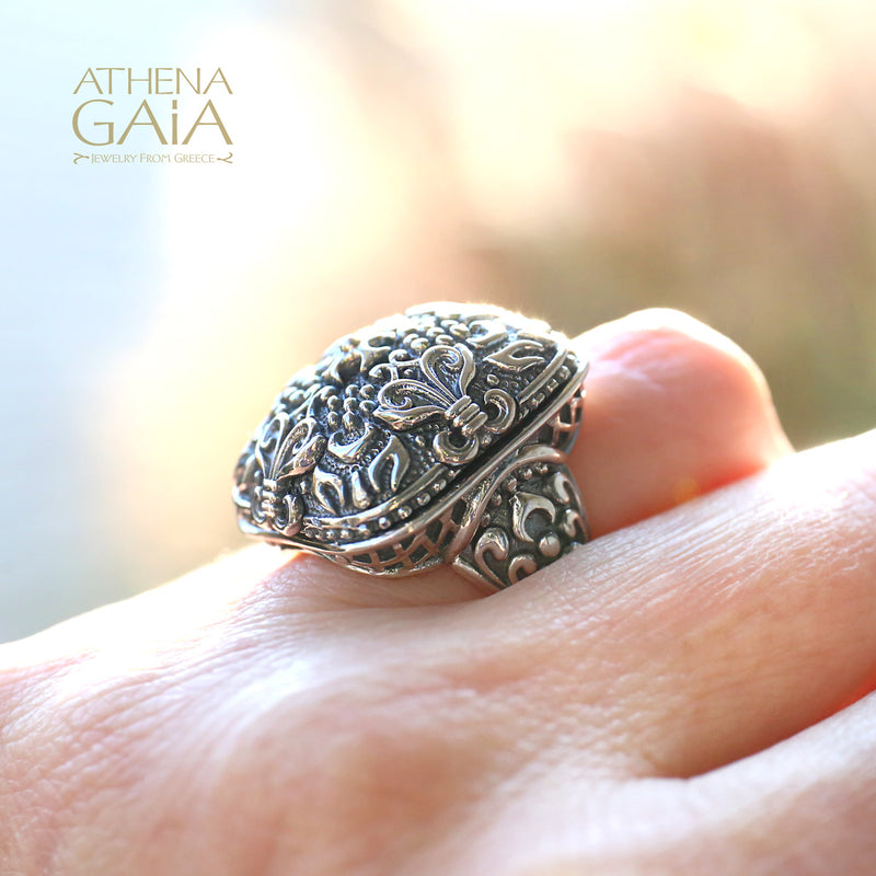 A large silver unisex ring with a floral pattern.