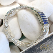Silver bracelet with blue stones on pebbles