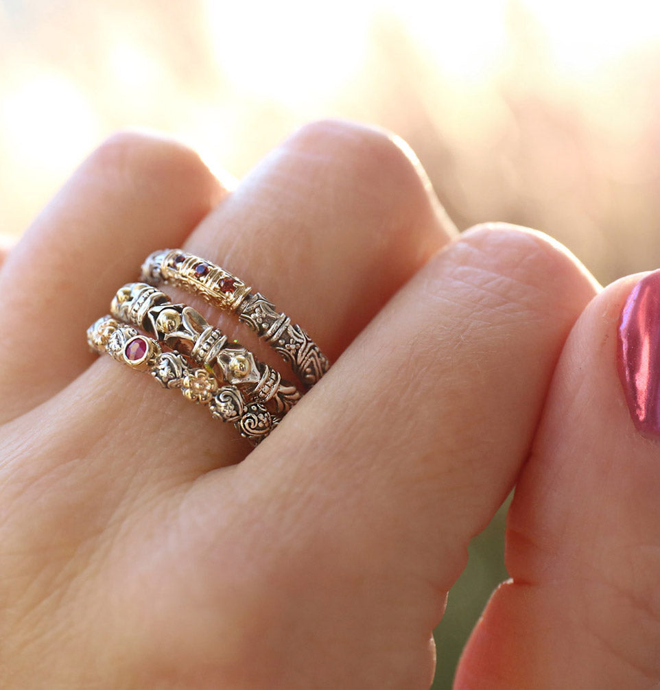 hand wearing 3 stackable two toned rings