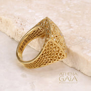 A gold square ring with intricate filigree details and diamonds on a stone with the Athena Gaia Jewelry logo visible.