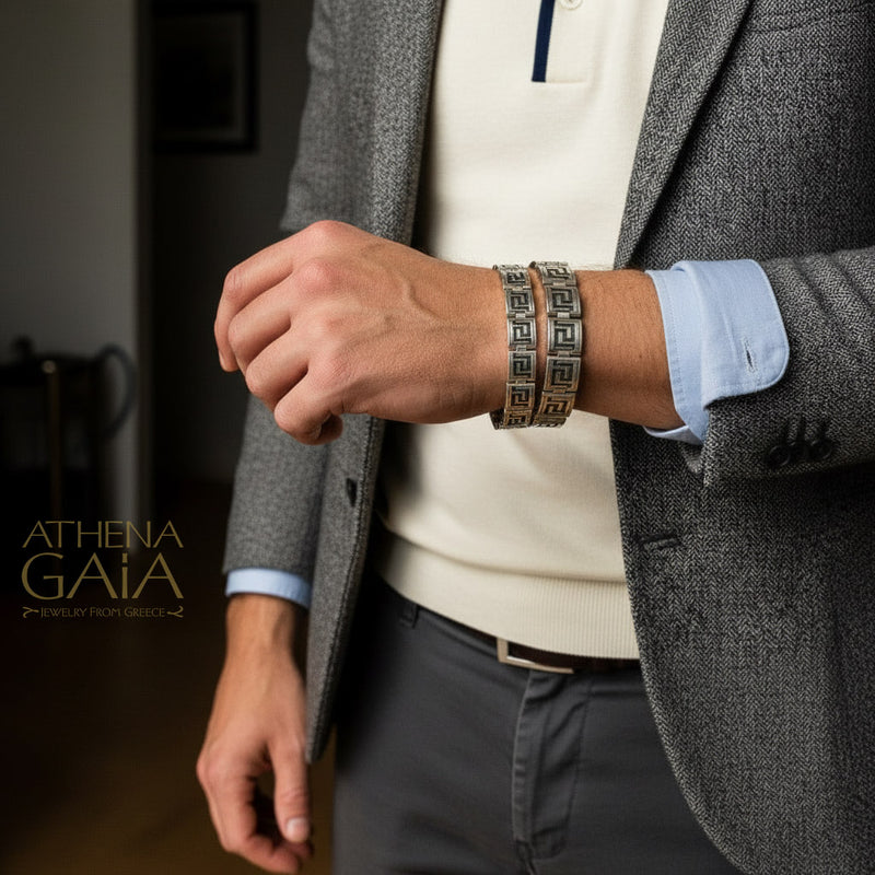 man wearing a gray blazer with visible silver mens jewelry