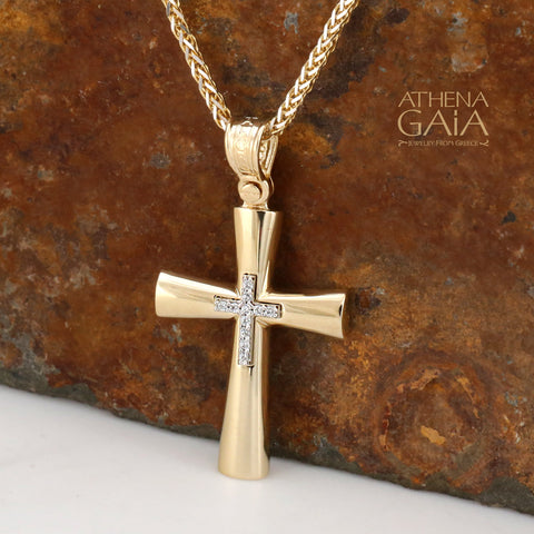 Gold Baptism cross necklace with diamond stones in the center against a dark background