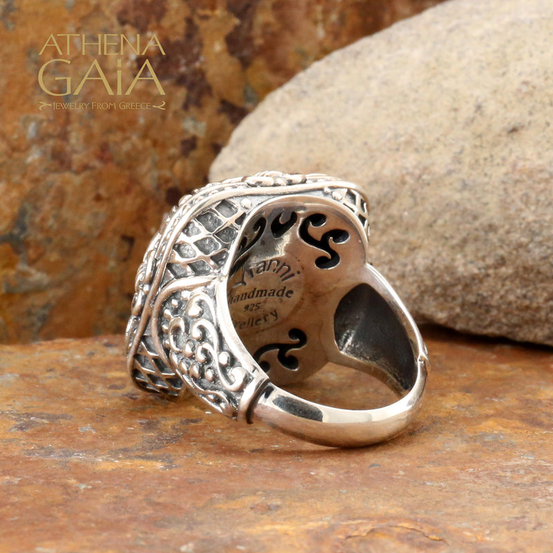 A large silver unisex ring with a floral pattern.
