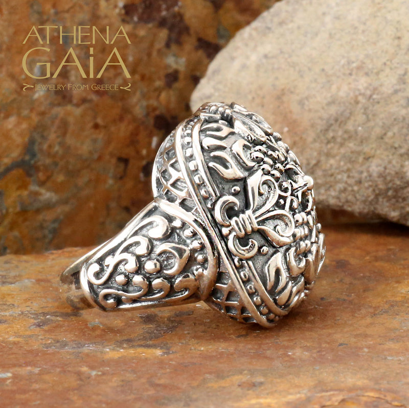 A large silver unisex ring with a floral pattern.