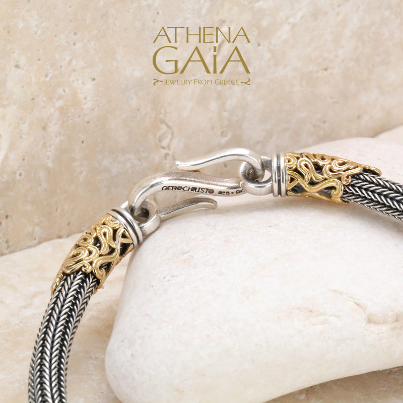 Elegant silver and gold bracelet with ruby-accented hook clasp, handcrafted in Greece.