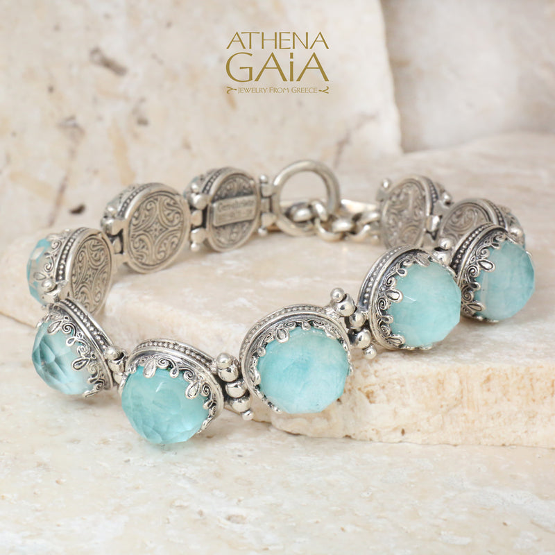Sterling silver bracelet adorned with luminous aquamarine gemstones and ornate filigree links, capturing the serene beauty of the Aegean Sea.