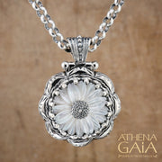 Silver pendant with a carved mother-of-pearl flower on a chain necklace.